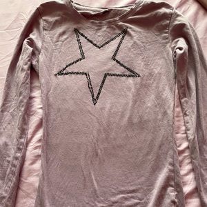 This is a long sleeved lavender shirt with a star that has rhinestones on top.